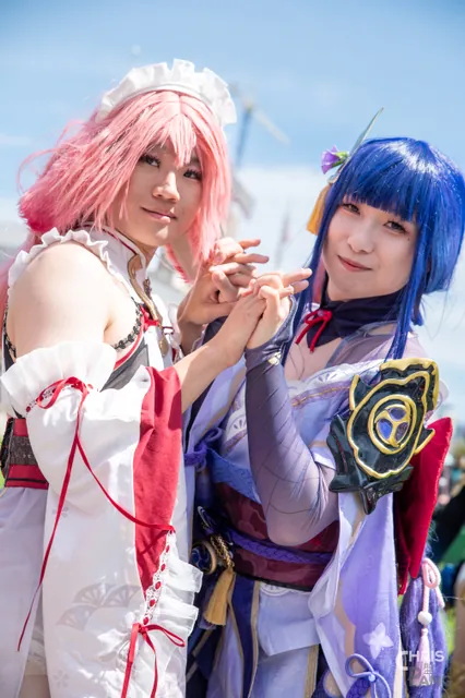 Photo by Christopher Pang / ChrisPang Productions. A cosplayer in a blue and white dress with a red flower, at the NorCal Cherry Blossom Festival cosplay parade.