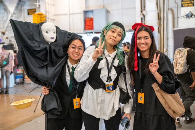 Photo by Christopher Pang / ChrisPang Productions. Three cosplayers in white and gold outfits on a ship deck at CarrierCon.