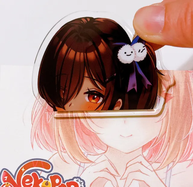 Merch example by Nekopon. A print of a woman with long pink hair in a white and blue outfit.