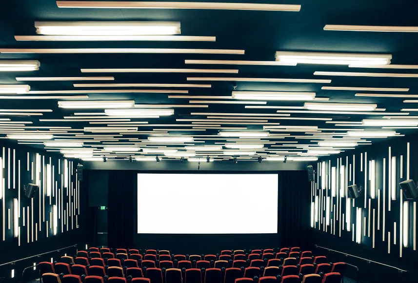 New People Cinema auditorium seen from the back, blank screen and rows of red seats