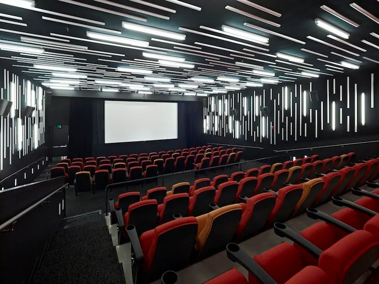 Angled view of red and yellow seats in the New People Cinema auditorium